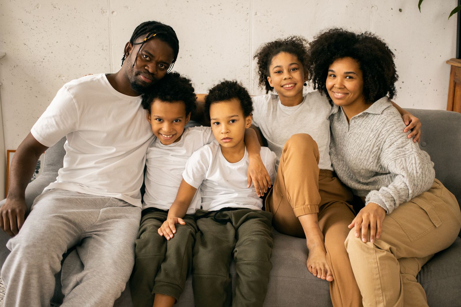 A family of five together on a sofa